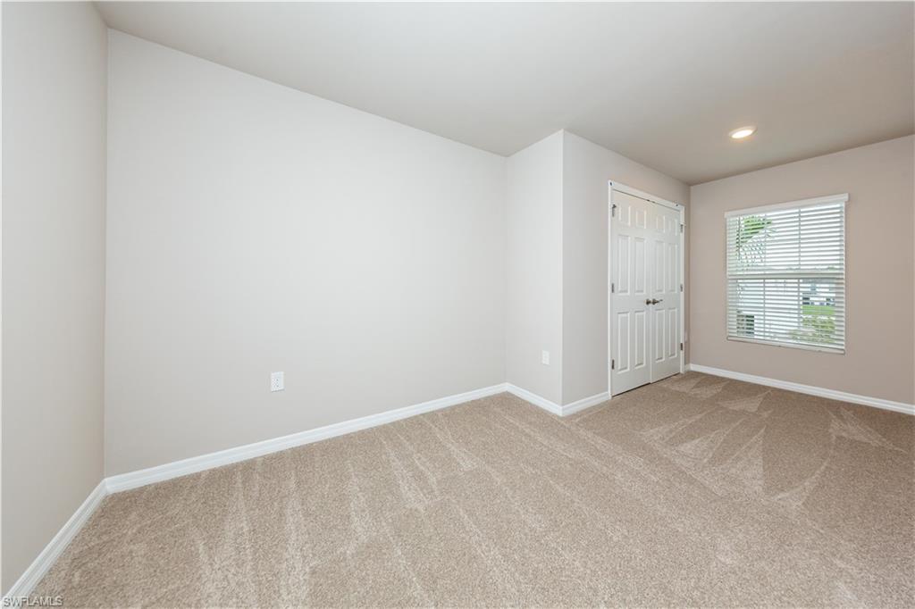 15307 Wildflower Circle Naples, FL 34119 - Photo 17 of 26 an empty room with windows