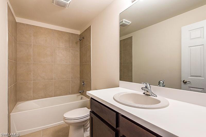 15307 Wildflower Circle Naples, FL 34119 - Photo 18 of 26 a bathroom with a sink and a mirror