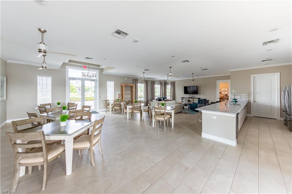 15307 Wildflower Circle Naples, FL 34119 - Photo 22 of 26 a dining room with furniture and view of kitchen