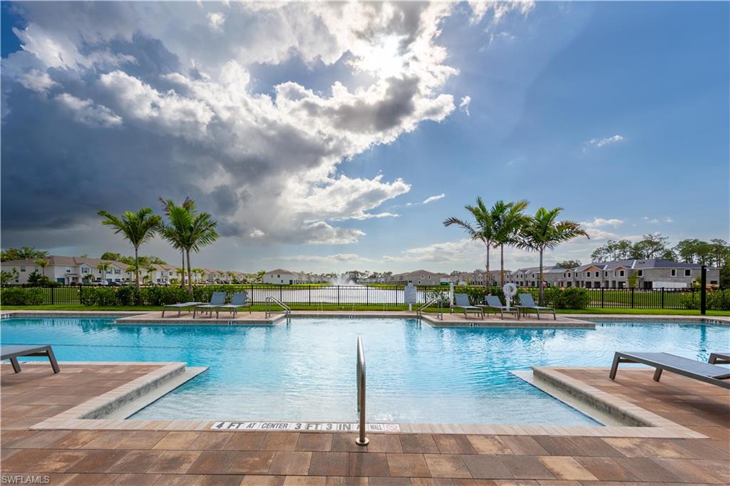 15307 Wildflower Circle Naples, FL 34119 - Photo 25 of 26 a view of a lake with houses in the back