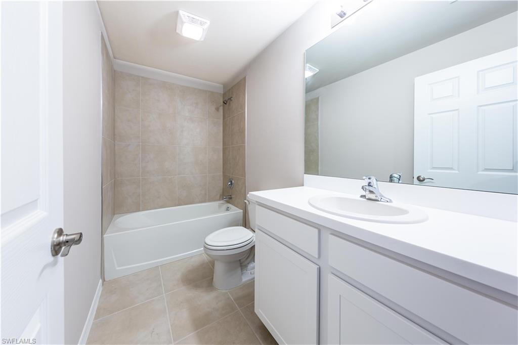 15307 Wildflower Circle Naples, FL 34119 - Photo 10 of 26 a bathroom with a sink a toilet and bathtub