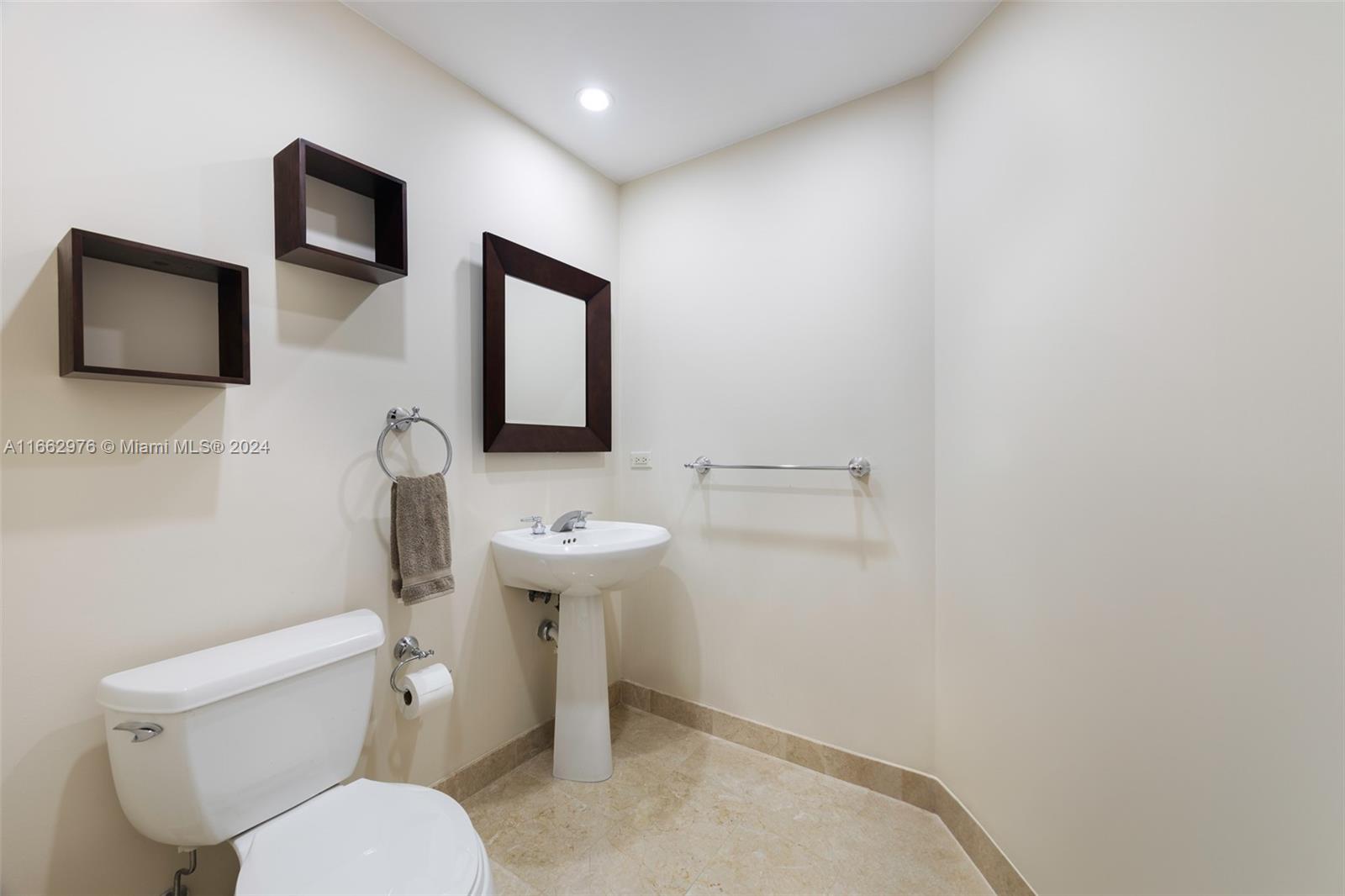 801 Brickell Key Boulevard, Unit 2008 Miami, FL 33131 - Photo 5 of 19 a bathroom with a toilet sink and mirror