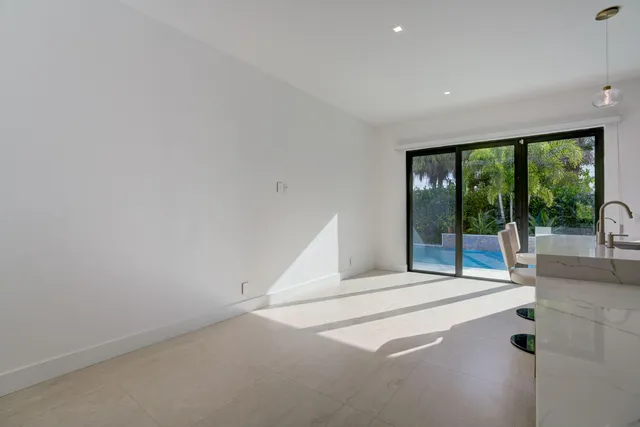 a spacious bedroom with a large window and a bed