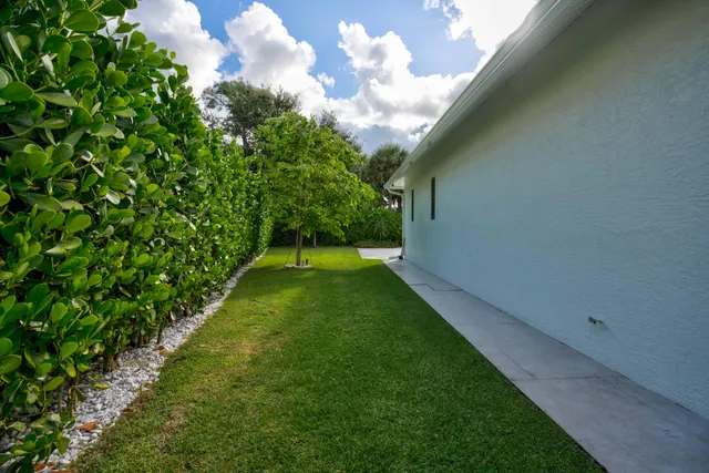 a kitchen with stainless steel appliances kitchen island granite countertop a table chairs and a refrigerator