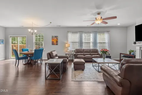 a kitchen with stainless steel appliances granite countertop a refrigerator stove a sink and white cabinets