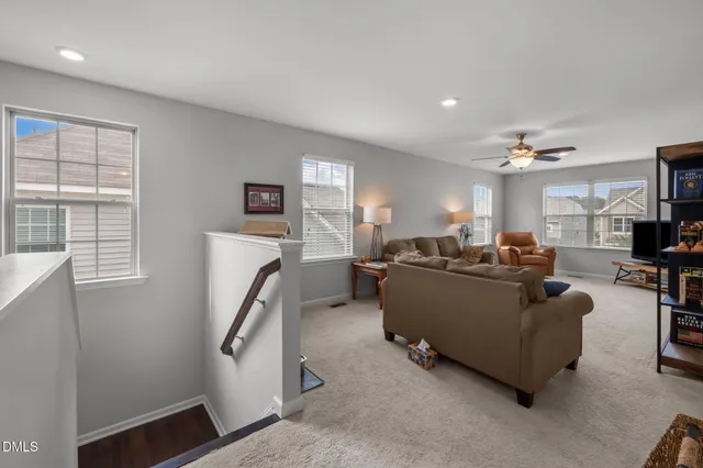 a living room with furniture and a lamp