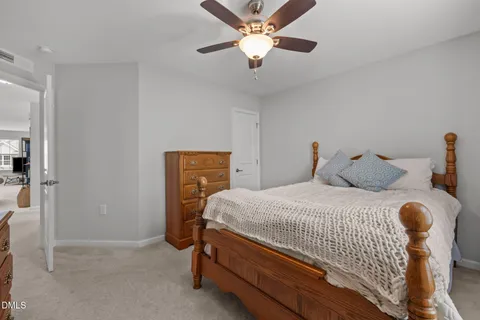 an empty room with windows and ceiling fan view