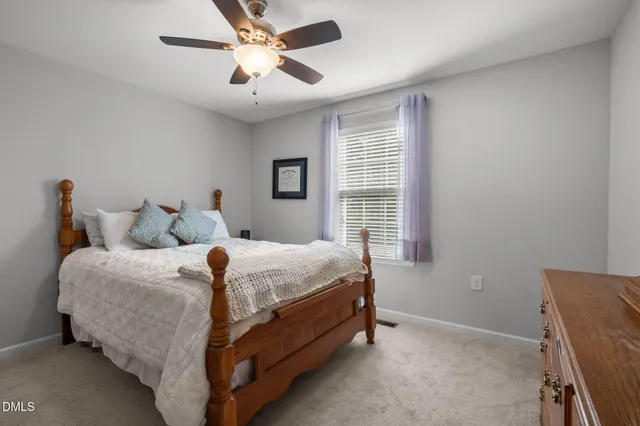 a bedroom with bed and a chandelier