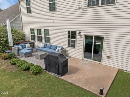 a view of backyard with seating space and trees