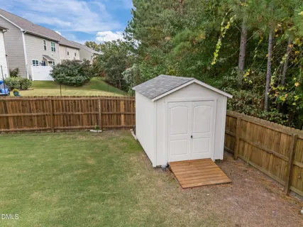a view of house with backyard and sitting area