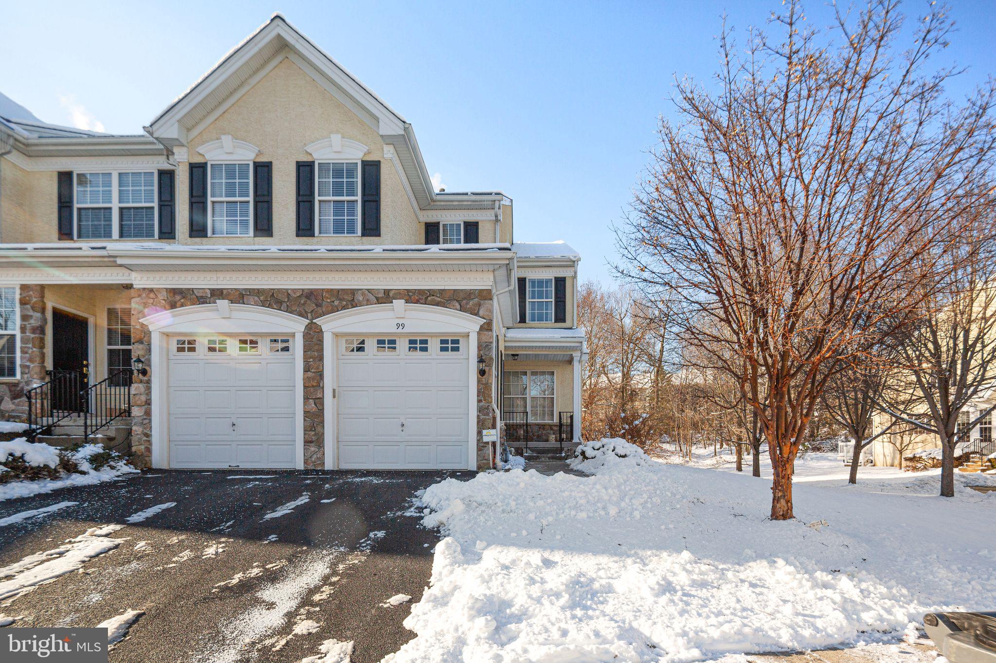 a front view of a house with a yard covered in snow