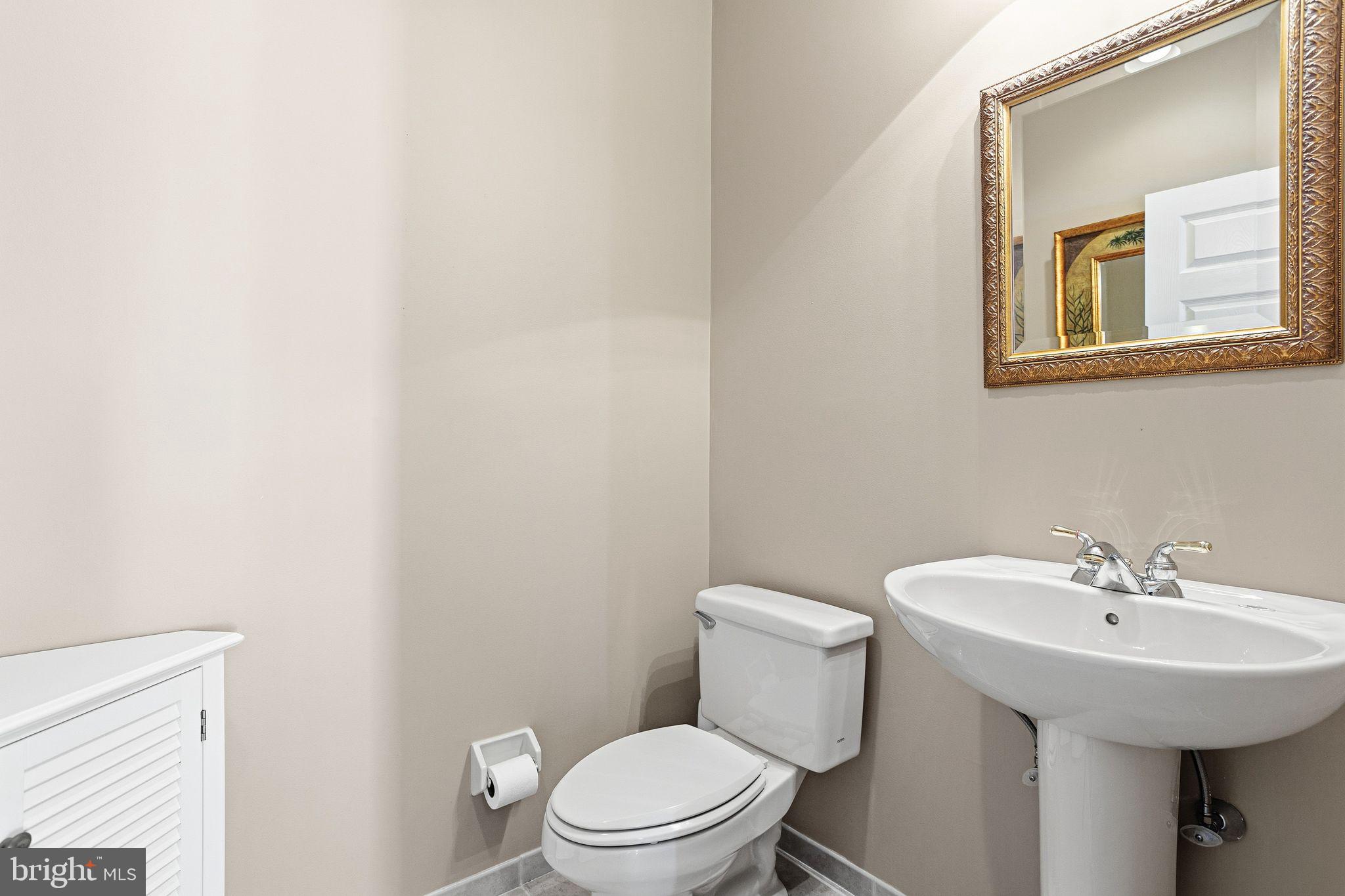 99 Longview Lane Newtown Square, PA 19073 - Photo 11 of 50 a bathroom with a sink a mirror and a toilet