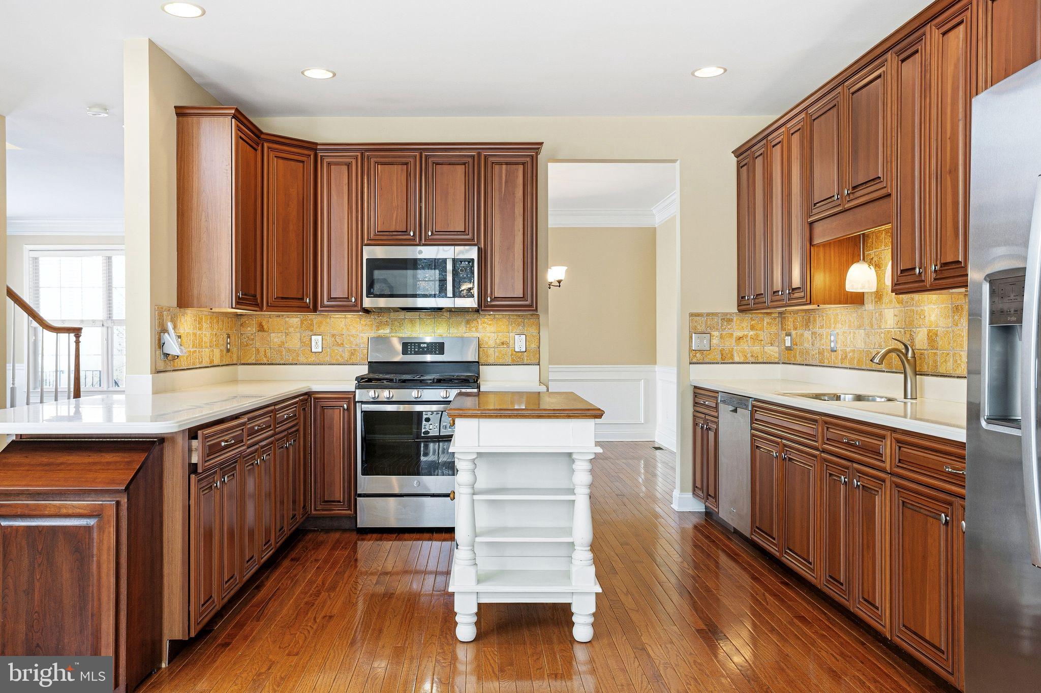 99 Longview Lane Newtown Square, PA 19073 - Photo 22 of 50 a kitchen with stainless steel appliances kitchen island granite countertop wooden cabinets and a stove top oven