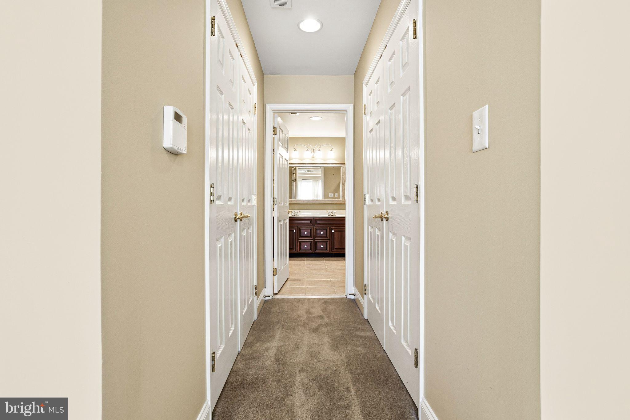 99 Longview Lane Newtown Square, PA 19073 - Photo 33 of 50 a view of a hallway with wooden shelves