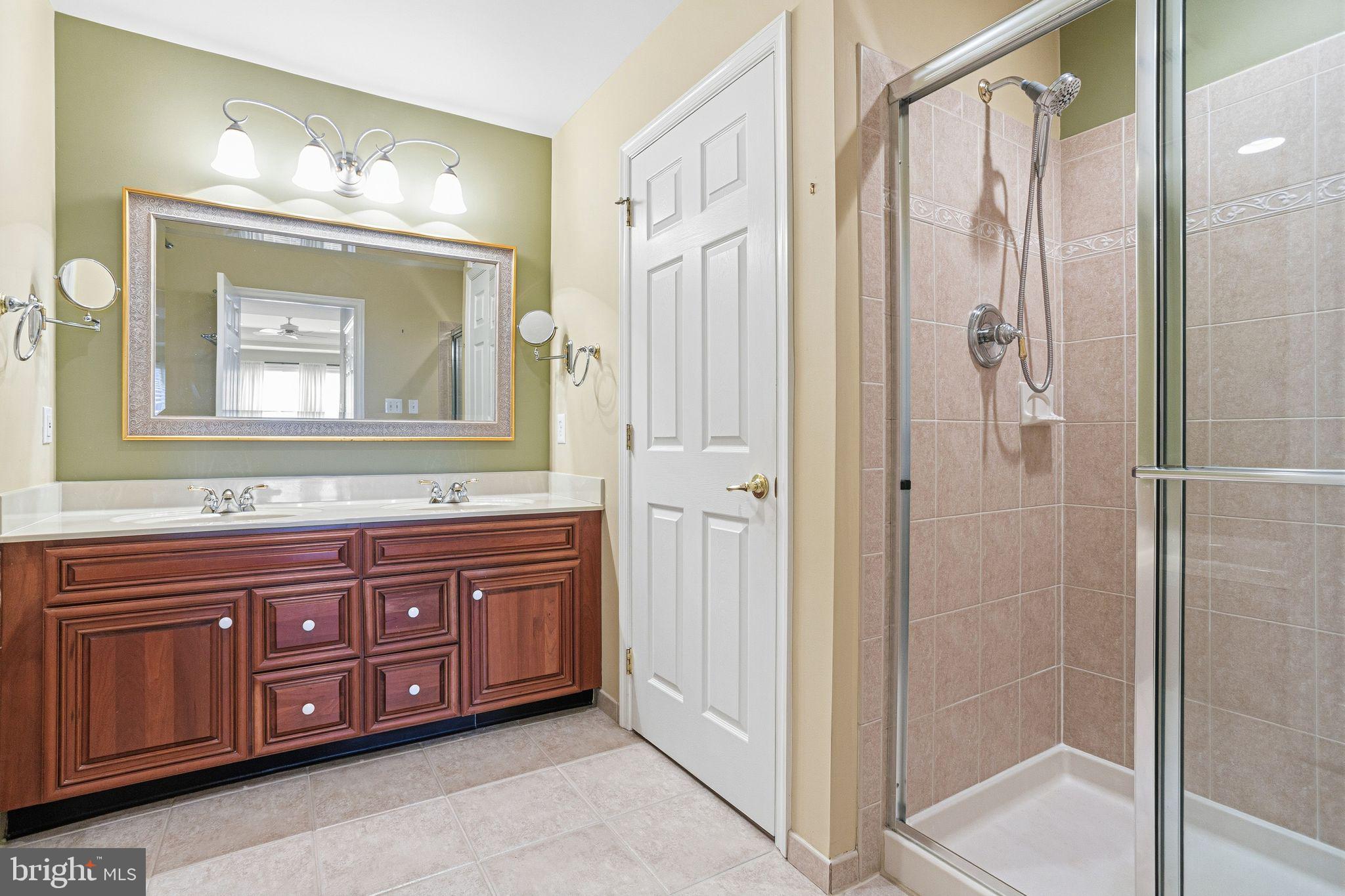 99 Longview Lane Newtown Square, PA 19073 - Photo 37 of 50 a bathroom with a double vanity sink and mirror with shower