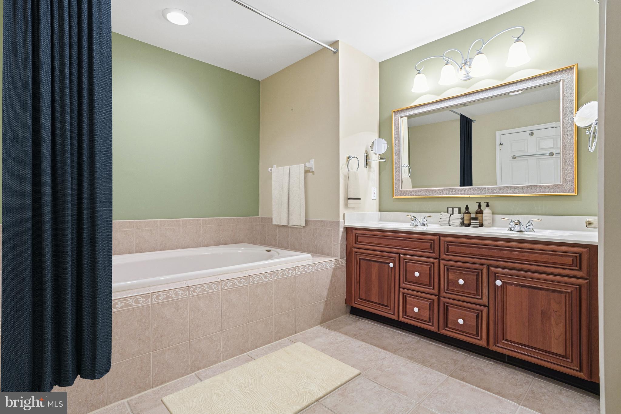 99 Longview Lane Newtown Square, PA 19073 - Photo 49 of 50 a bathroom with a tub sink double vanity and a mirror