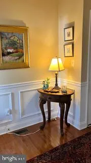 a lamp on a table and a refrigerator