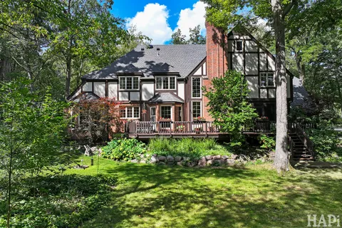 a aerial view of a house with a big yard plants and large trees