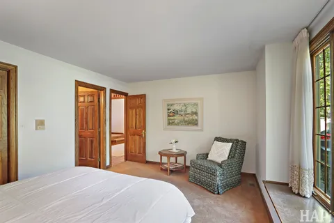 a living room with furniture a lamp and a large window