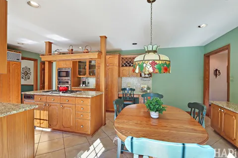 a view of staircase with lots of frames on wall and a window