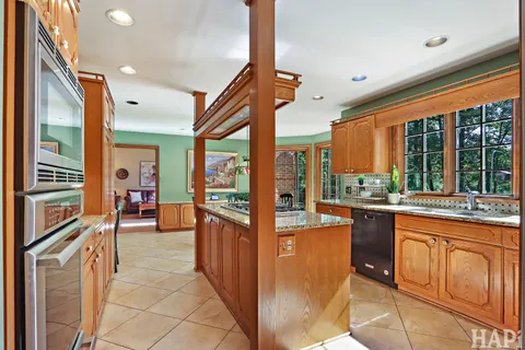 a living room with lots of furniture and a book shelf