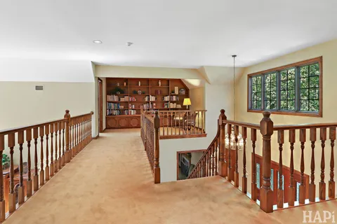 a bedroom with a bed and large windows