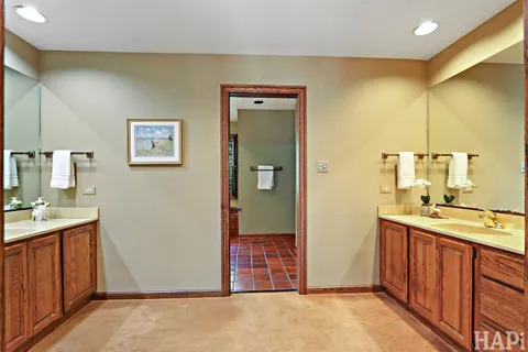 a bathroom with a double vanity sink and a mirror