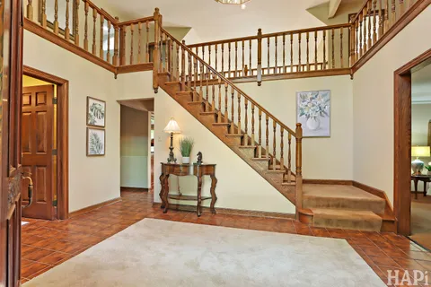 a view of an entryway wooden floor and chandelier