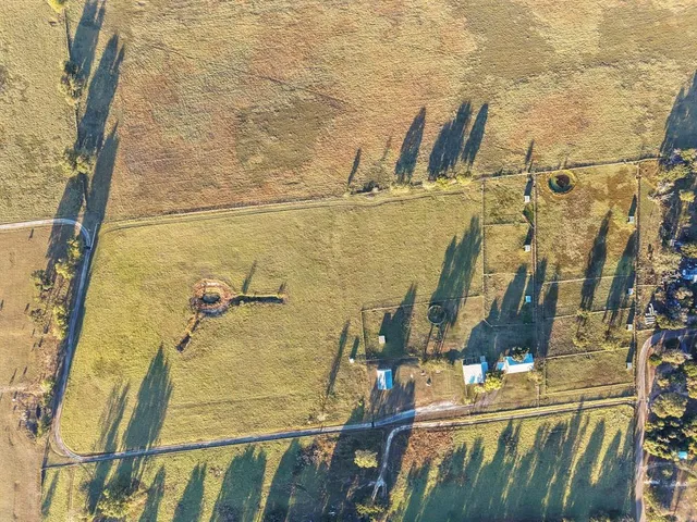 an aerial view of a residential building with outdoor space