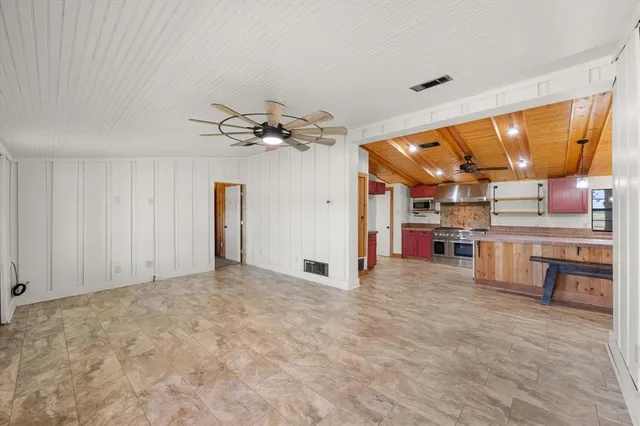 a kitchen with cabinets appliances and a counter space