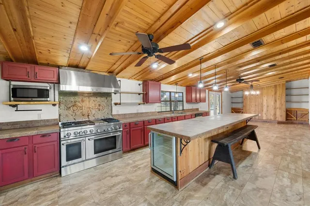 a room with pool table and windows