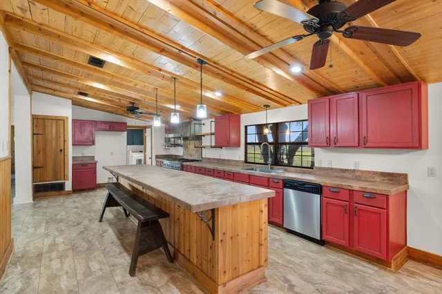 a kitchen with stainless steel appliances granite countertop a sink and wooden cabinets