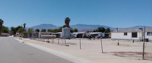 a view of a parking space and a car parked on the roadside