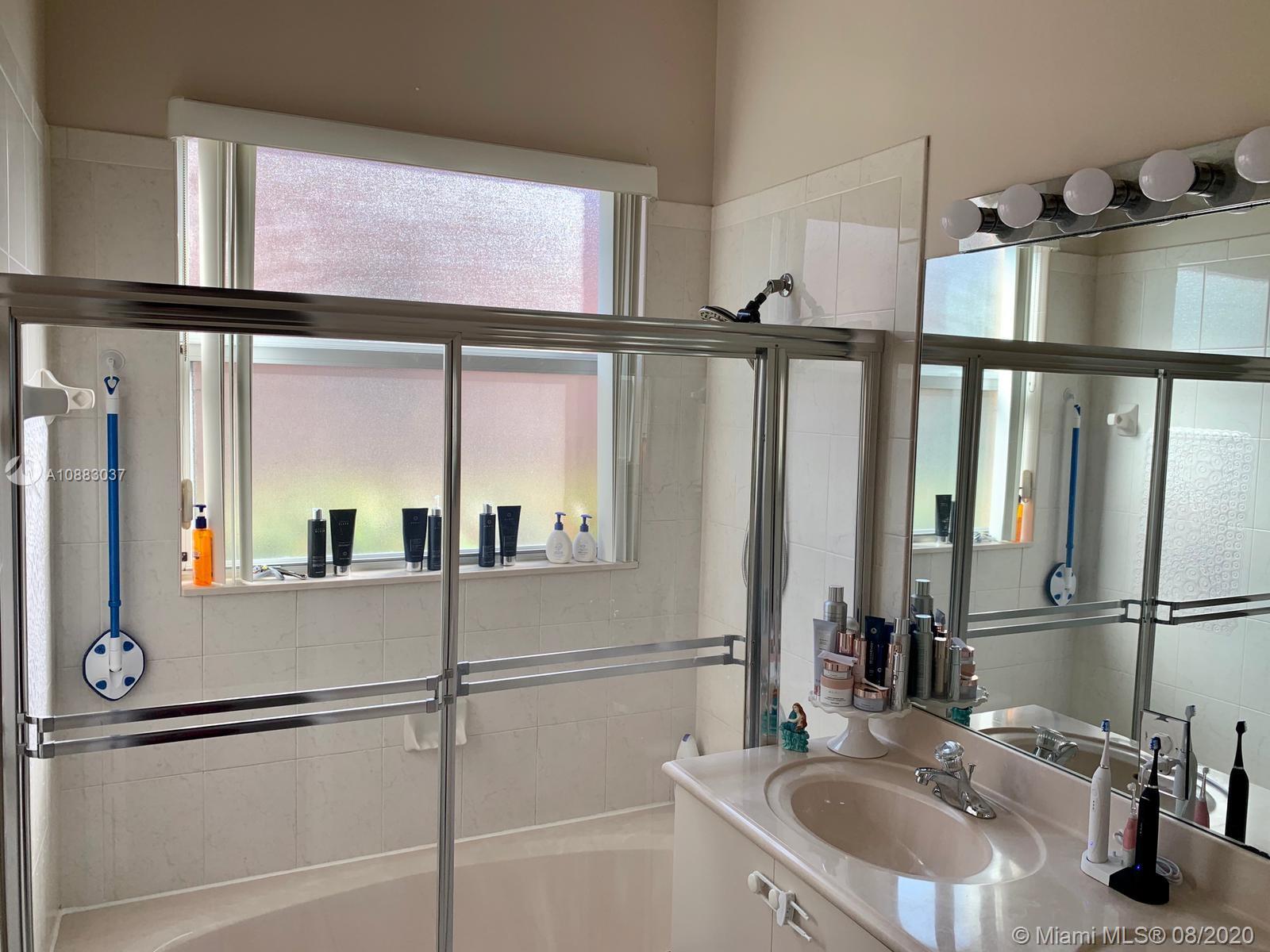 2329 Northeast 37th Road Homestead, FL 33033 - Photo 11 of 24 a bathroom with a sink and a large mirror