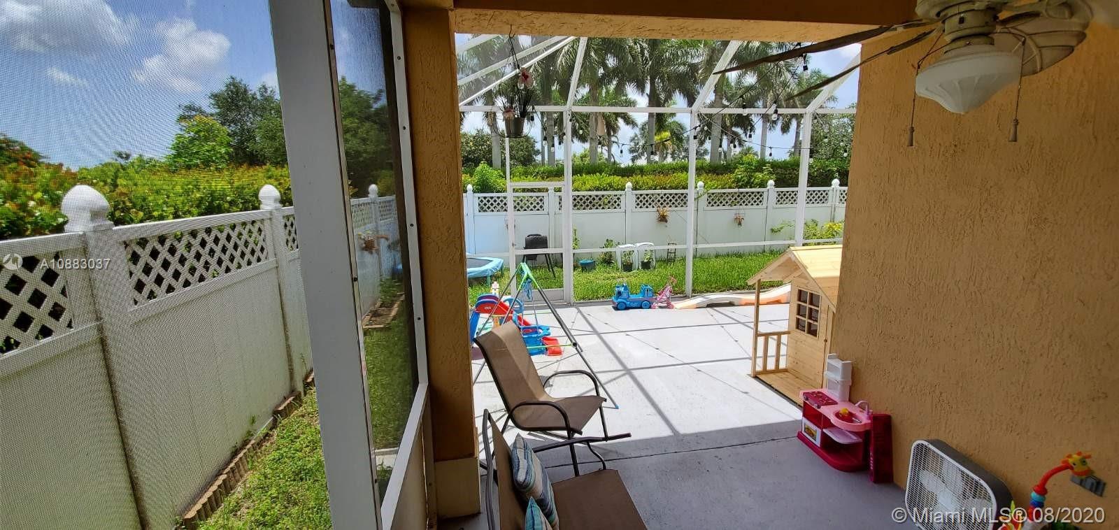 2329 Northeast 37th Road Homestead, FL 33033 - Photo 13 of 24 a view of balcony with two chairs and a potted plant