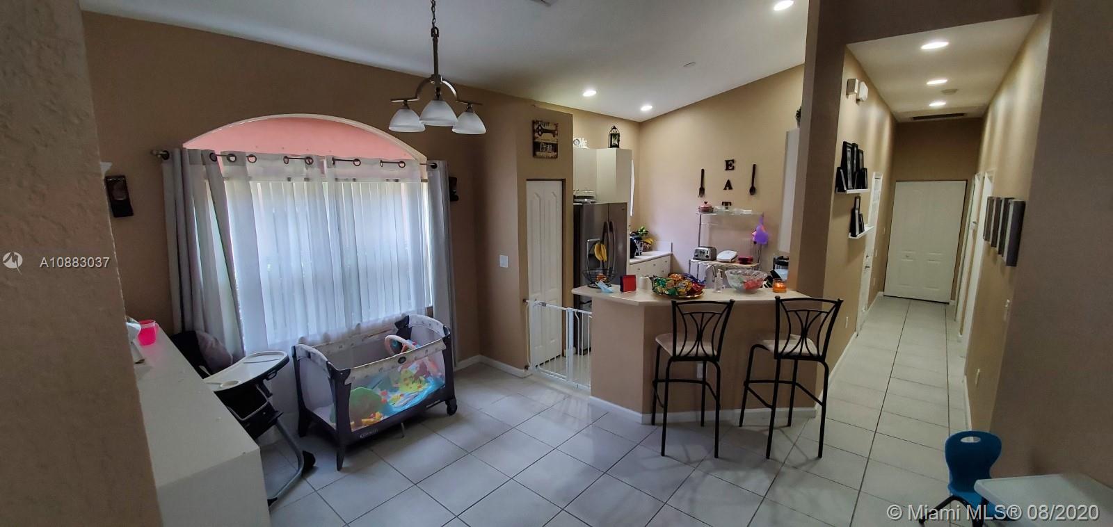 2329 Northeast 37th Road Homestead, FL 33033 - Photo 14 of 24 a view of a dining room with furniture and a chandelier
