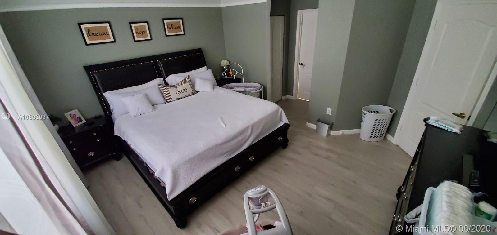 2329 Northeast 37th Road Homestead, FL 33033 - Photo 15 of 24 a bed sitting in a bedroom and mirror