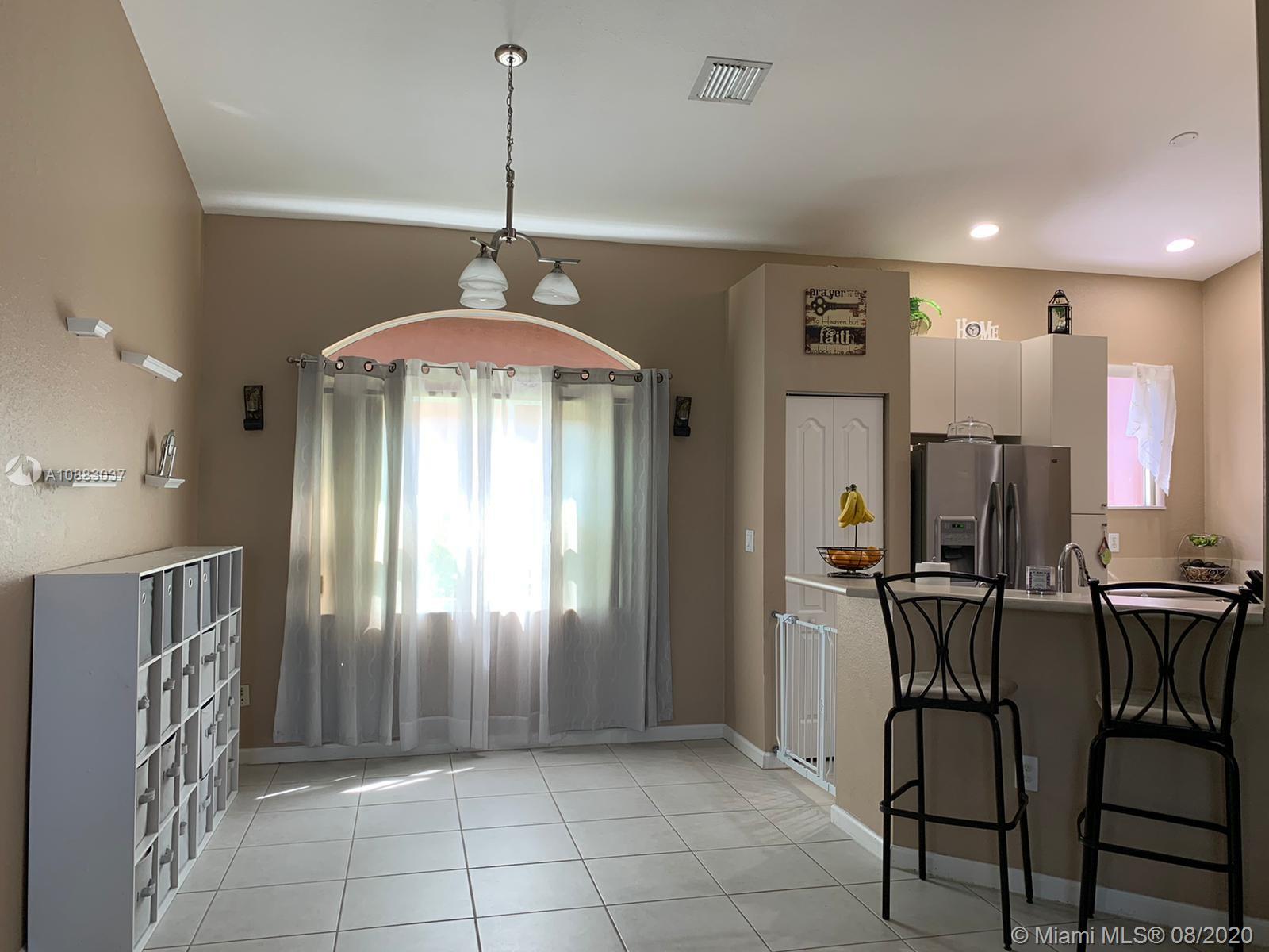 2329 Northeast 37th Road Homestead, FL 33033 - Photo 16 of 24 a view of a kitchen with furniture and chandelier