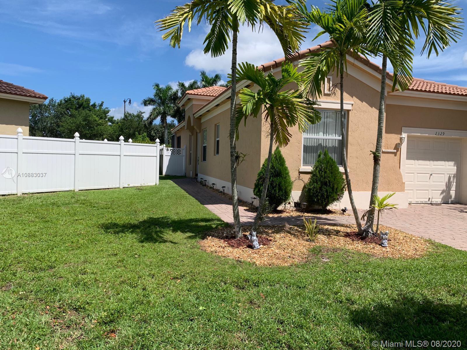 2329 Northeast 37th Road Homestead, FL 33033 - Photo 19 of 24 a view of backyard with palm trees