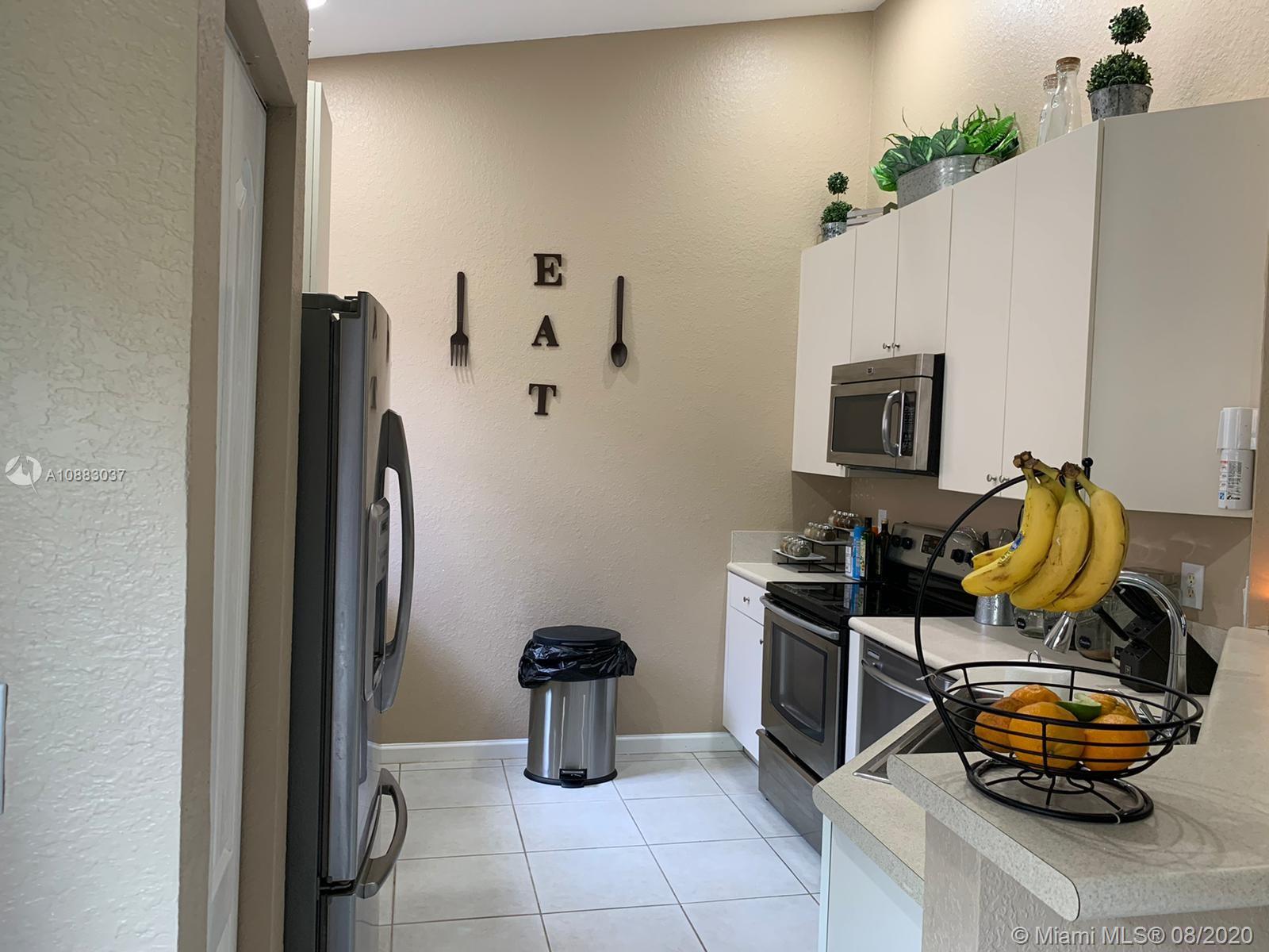 2329 Northeast 37th Road Homestead, FL 33033 - Photo 2 of 24 a bedroom with a bed and a couch