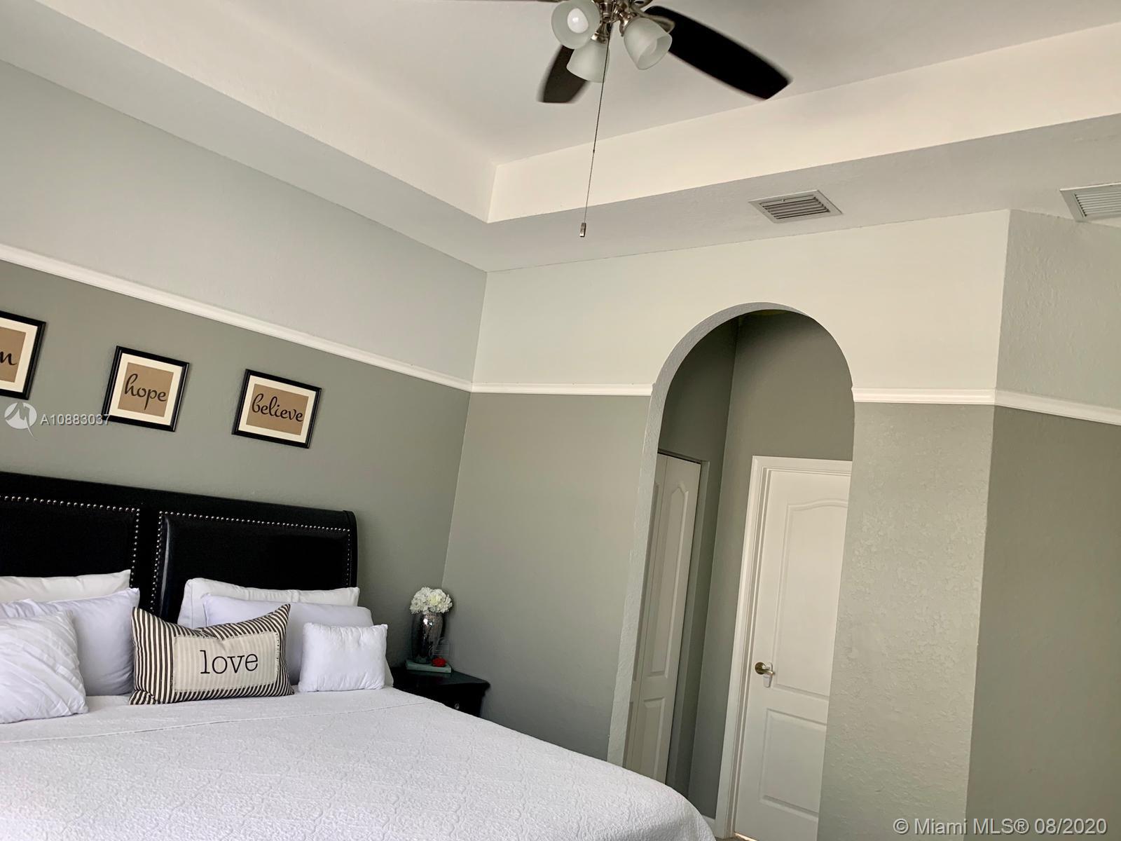 2329 Northeast 37th Road Homestead, FL 33033 - Photo 22 of 24 a bedroom with a bed and a mirror