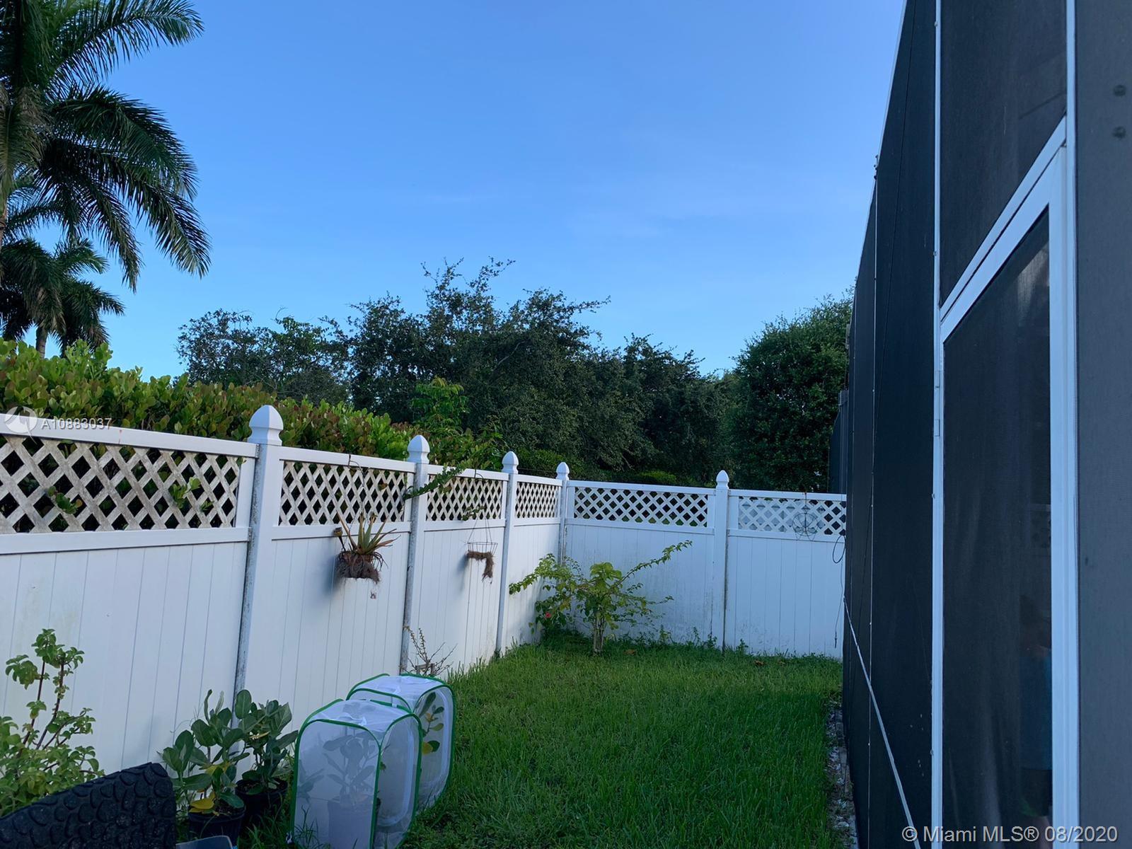 2329 Northeast 37th Road Homestead, FL 33033 - Photo 4 of 24 a view of a wooden fence and a bench