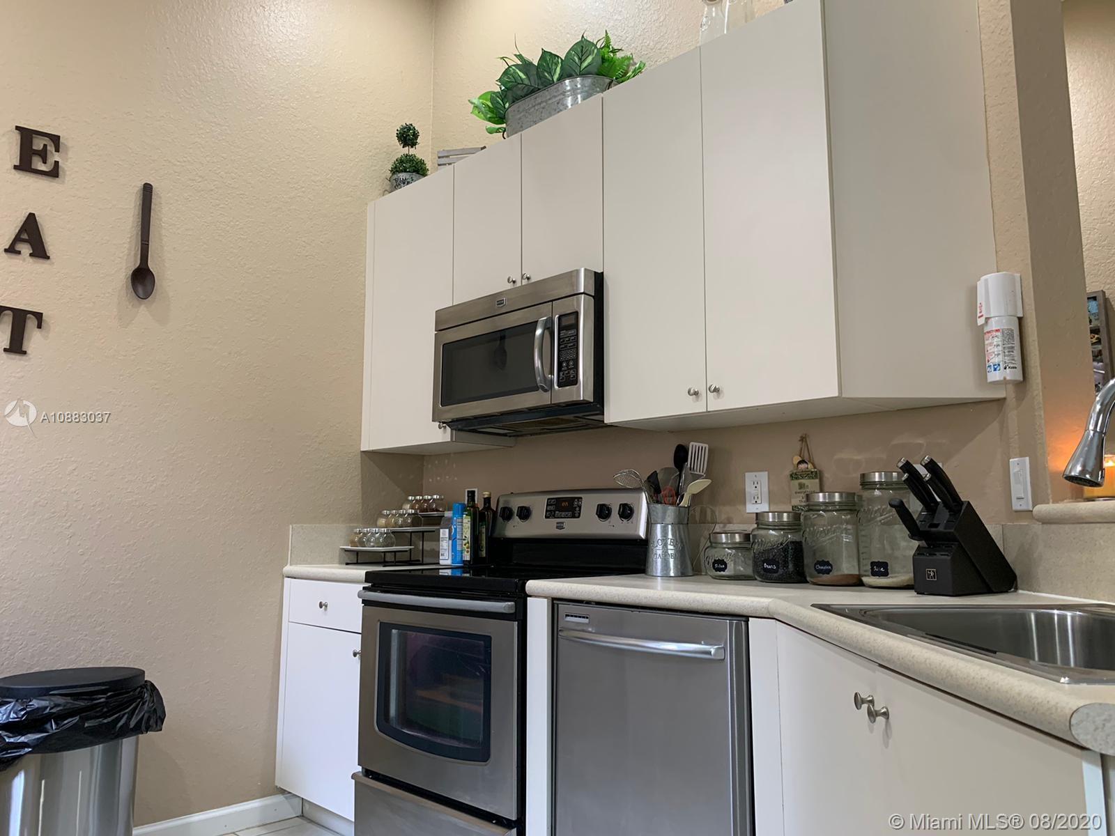 2329 Northeast 37th Road Homestead, FL 33033 - Photo 5 of 24 a kitchen with appliances a sink and cabinets