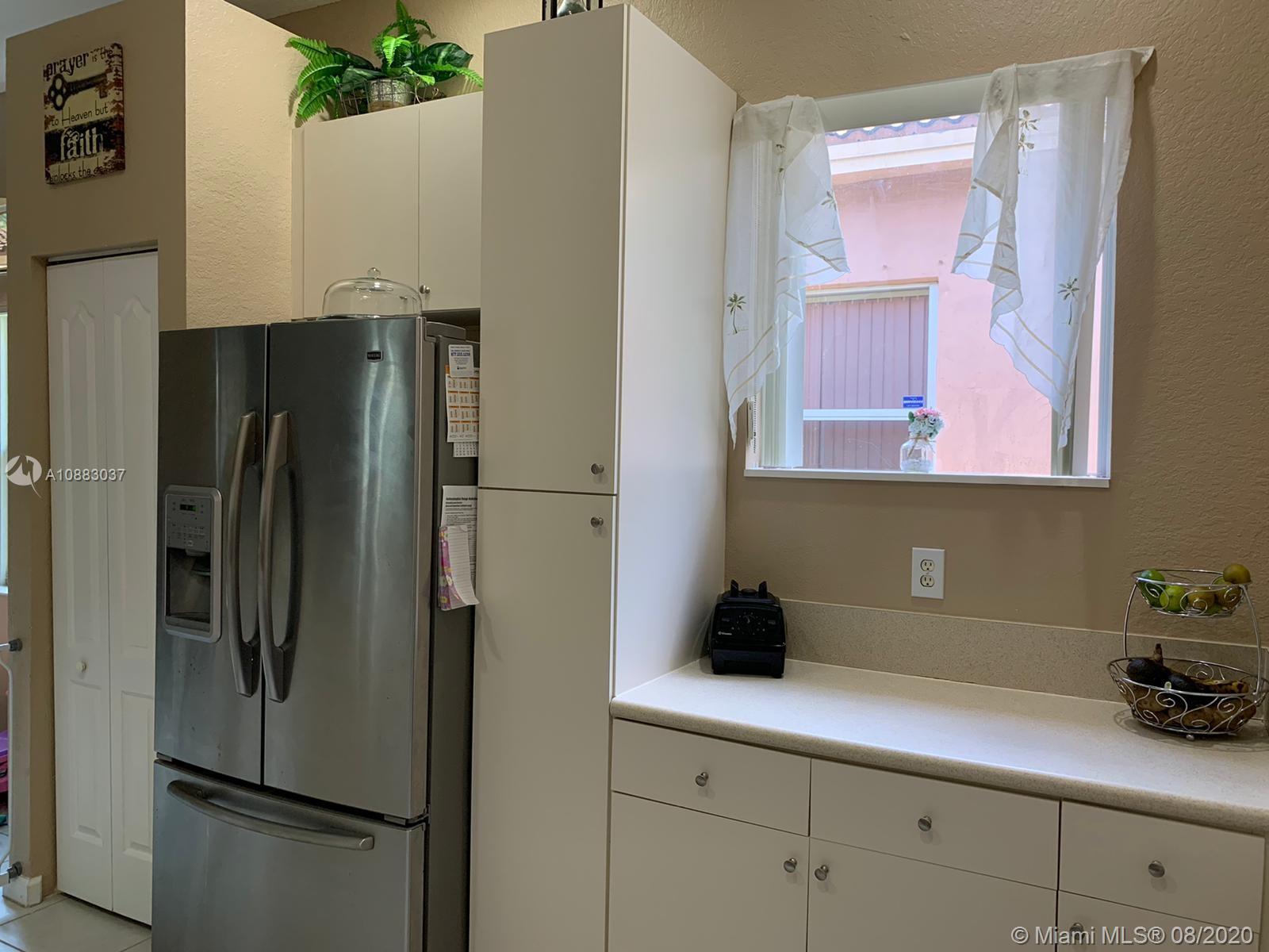 2329 Northeast 37th Road Homestead, FL 33033 - Photo 6 of 24 a kitchen with a refrigerator and cabinets