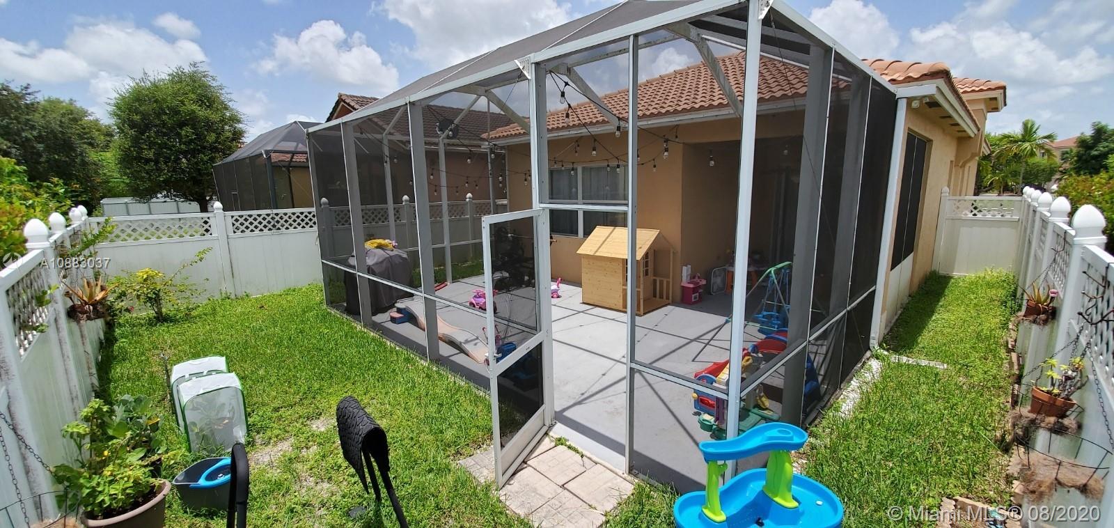 2329 Northeast 37th Road Homestead, FL 33033 - Photo 8 of 24 a view of an chair and table in backyard of the house