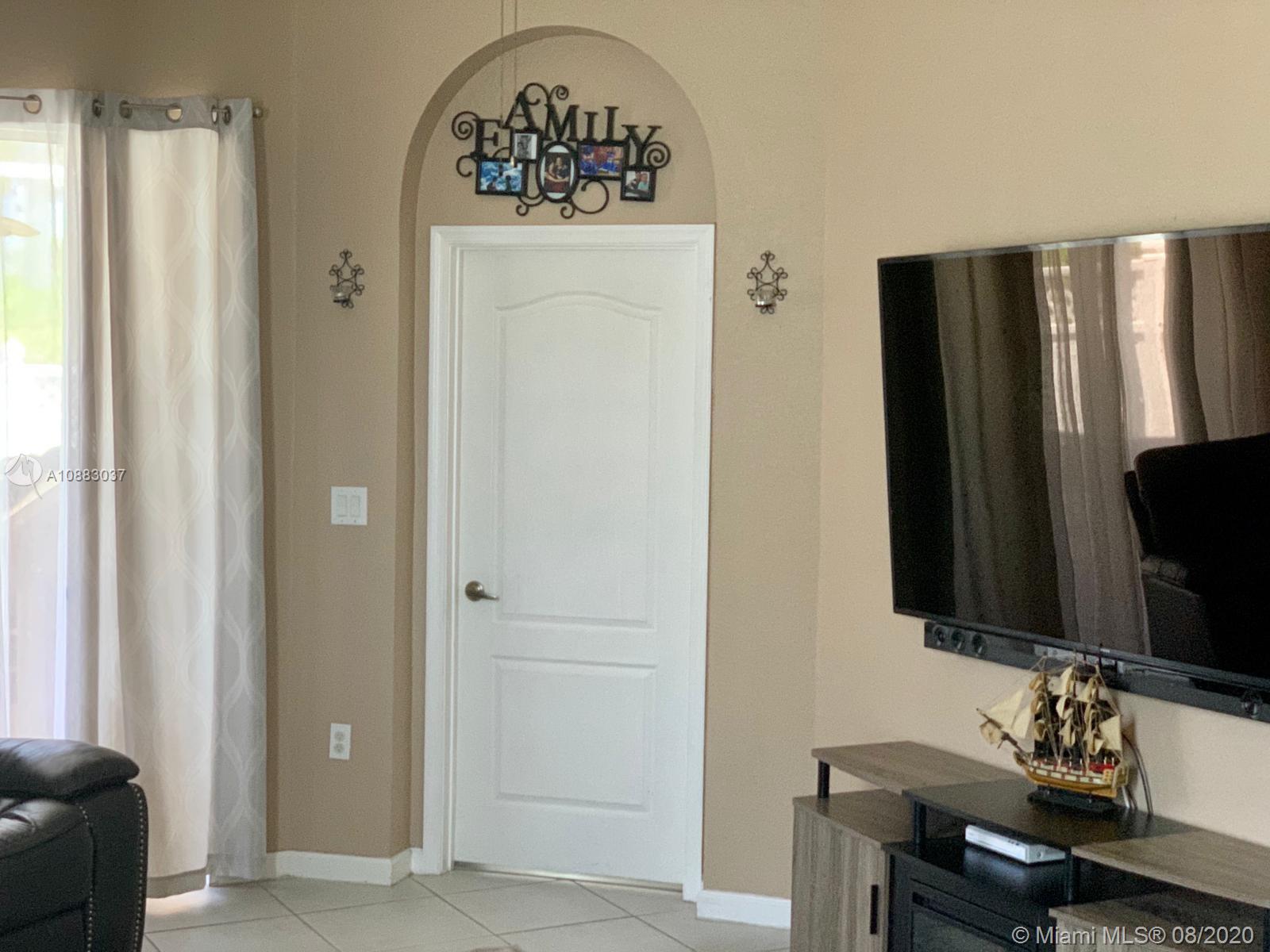 2329 Northeast 37th Road Homestead, FL 33033 - Photo 9 of 24 a bathroom with a sink a mirror and a window