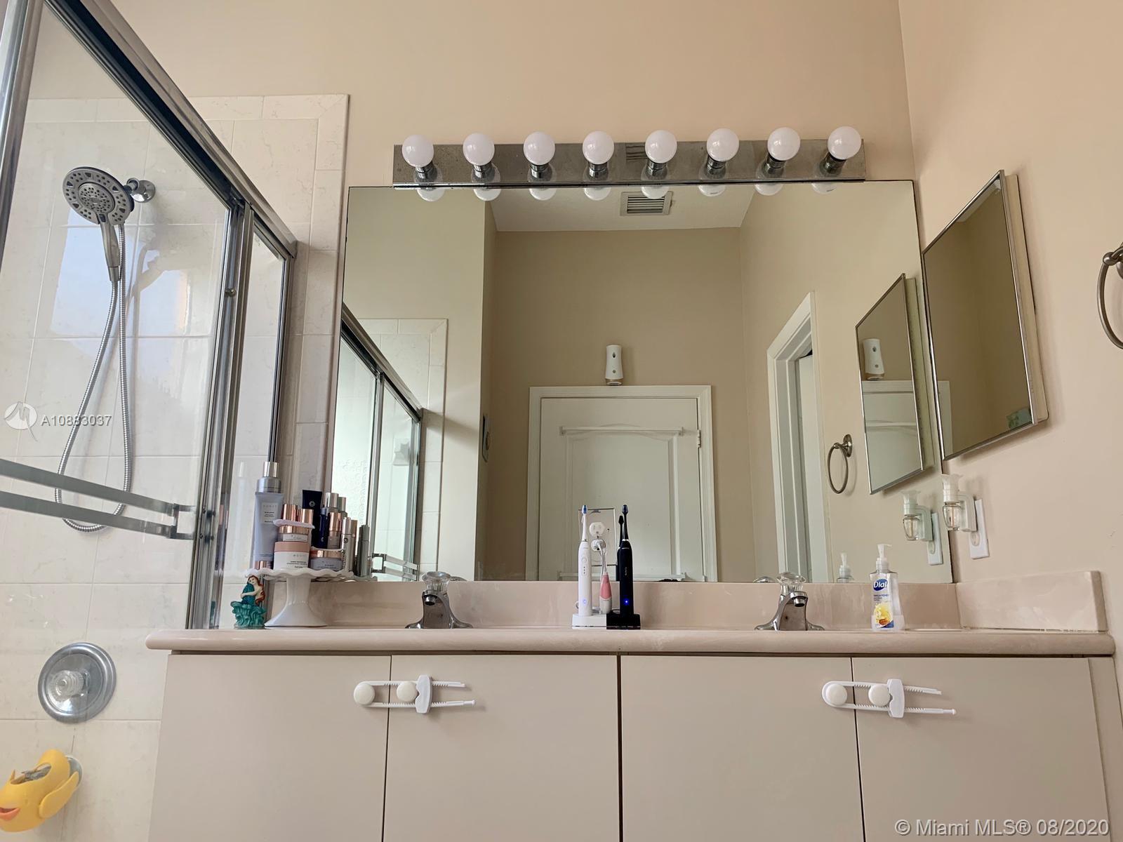 2329 Northeast 37th Road Homestead, FL 33033 - Photo 10 of 24 a bathroom with a sink and a mirror
