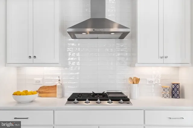 a stove top oven sitting inside of a kitchen