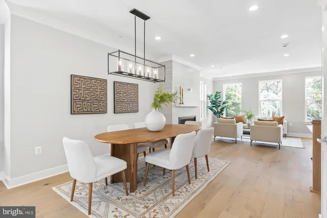 a living room with fireplace furniture and a large window