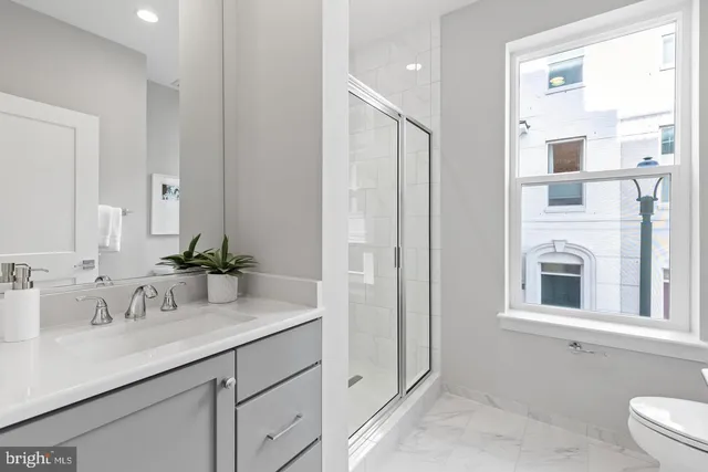 a bathroom with a shower sink and mirror